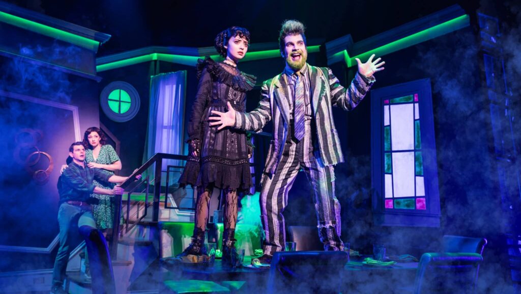 Beetlejuice-3 | Carvd N Stone (L-R): Will Burton as Adam Maitland, Megan McGinnis as Barbara Maitland, Isabella Esler as Lydia Deetz, and Justin Collette as Beetlejuice.