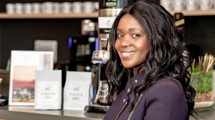 Kahawa 1893 owner Margaret Nyamumbo holding a cup of her coffee. (Photo courtesy of Margaret Nyamumbo)